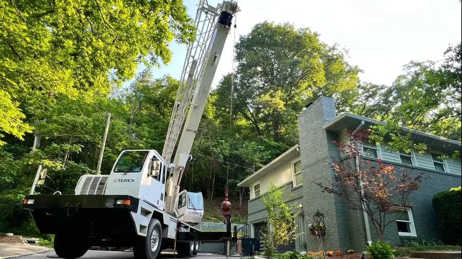 Crane truck staged for a large commercial tree removal